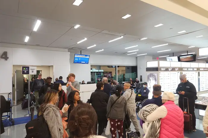 A crowd of people at JFK Airport